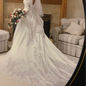 Beautiful very detailed White a wedding gown,professionally cleaned. Bustled.